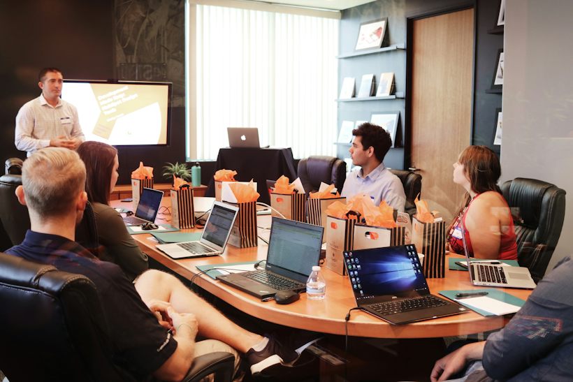 A deal team in a workshop while a colleague presents