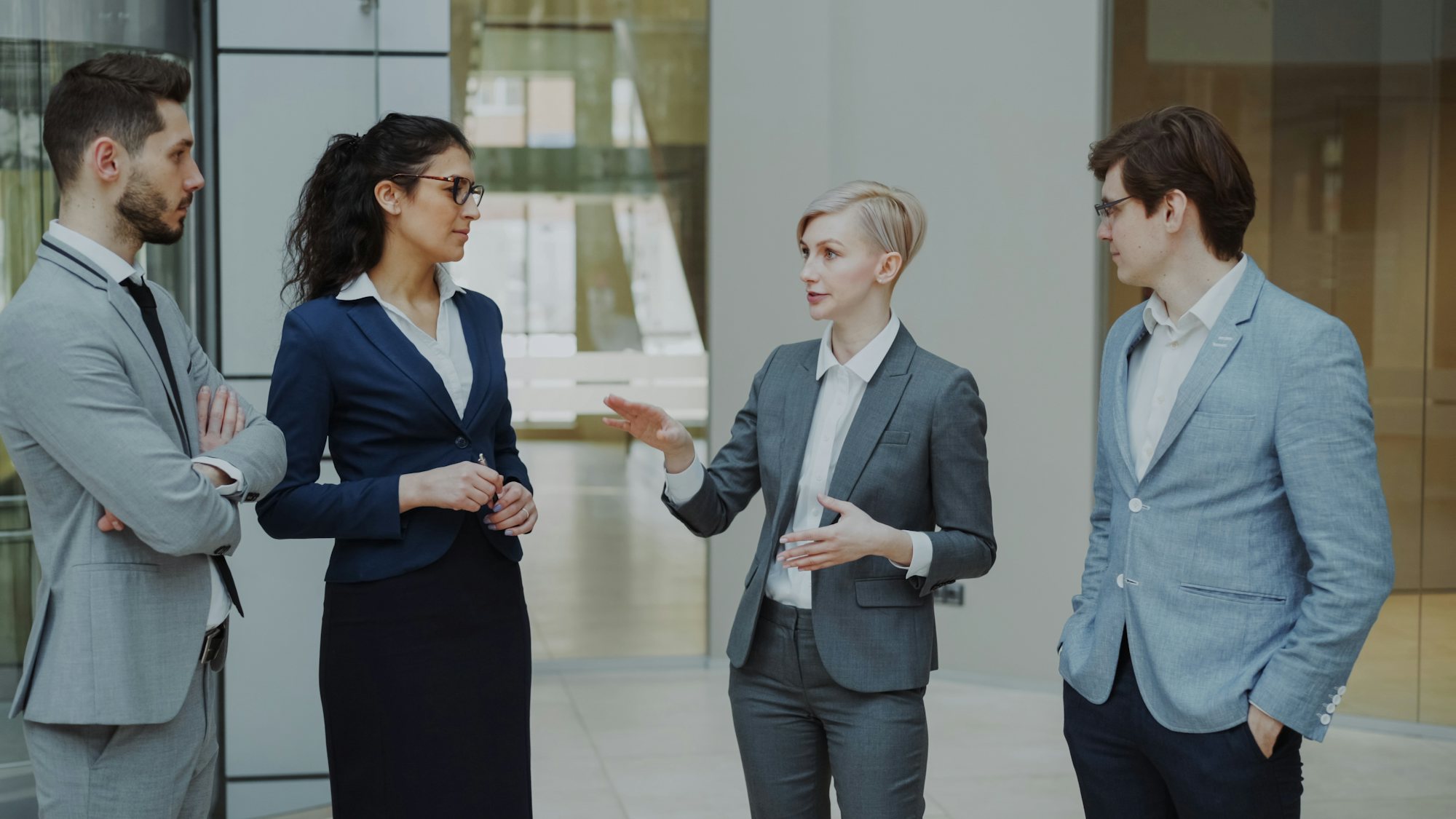 Four business advisors in discussion in a modern office
